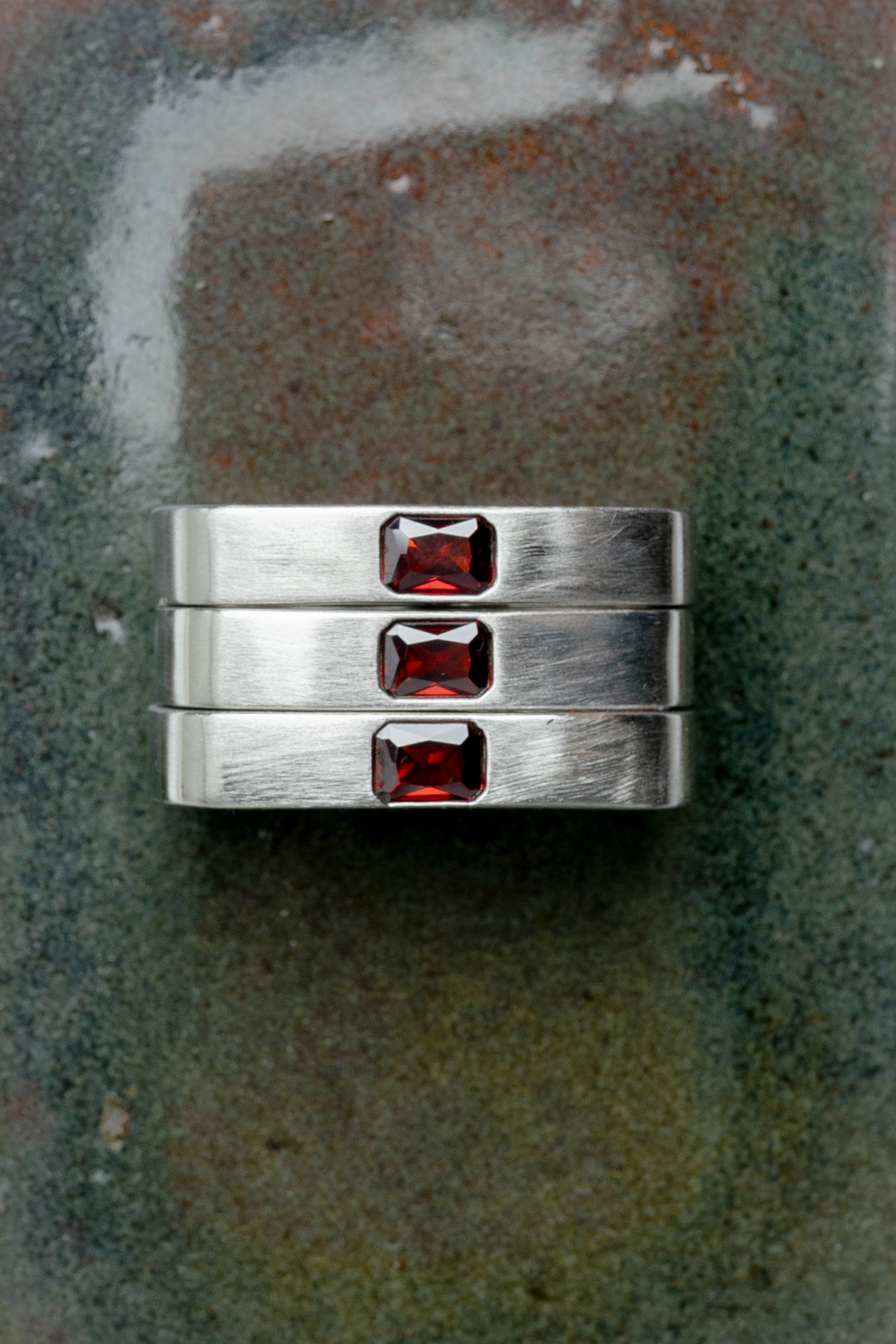 Maison Nwar ring set styled on textured surface, editorial product photo