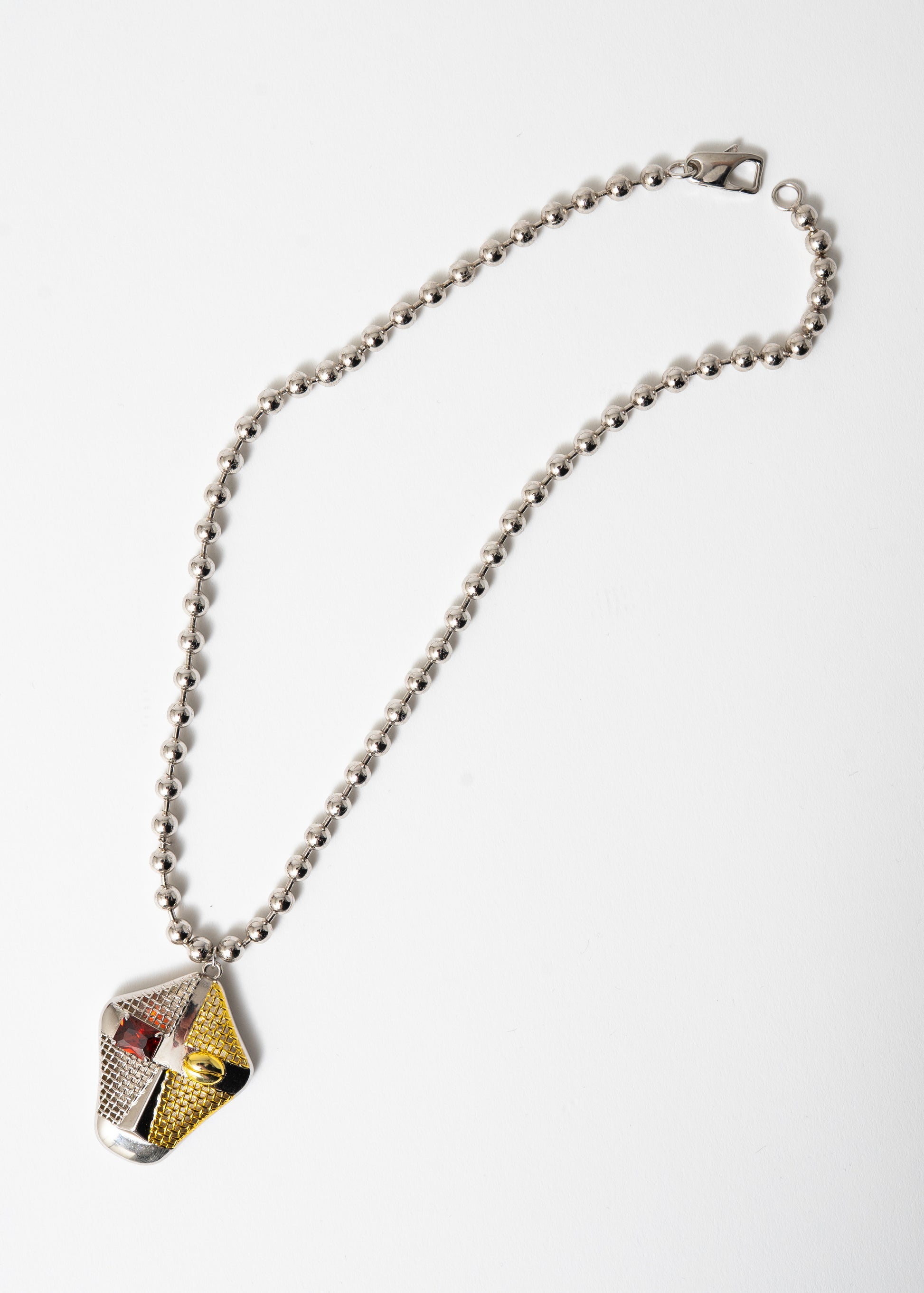 Maison Nwar satin link necklace in sterling silver with sculptural red CZ pendant