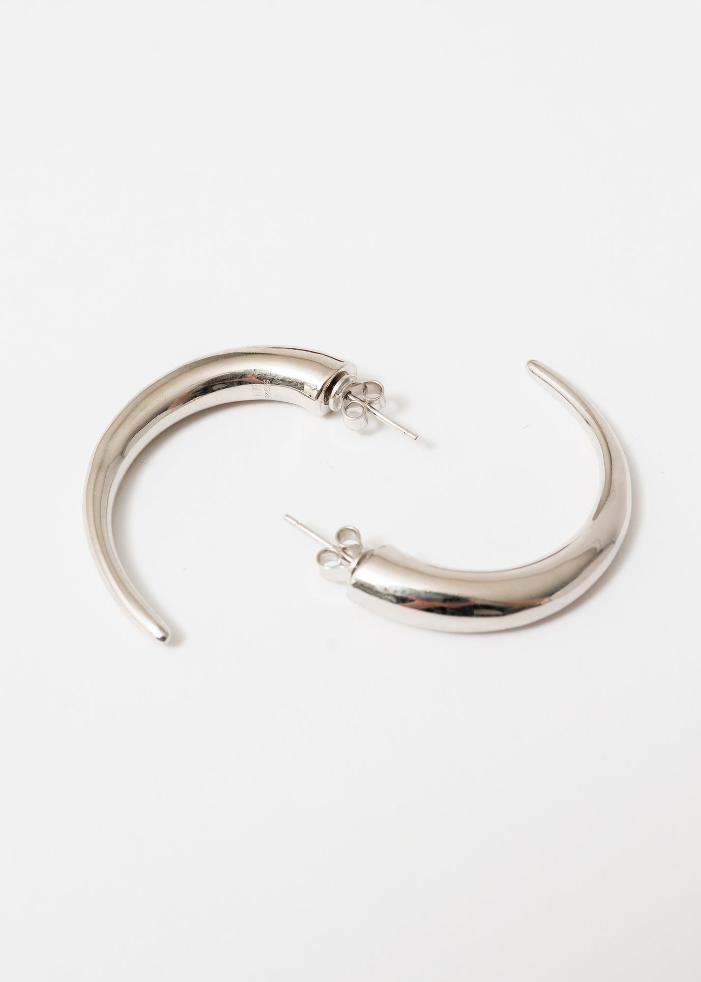 Maison Nwar sculptural silver hoop earring — S925 sterling silver with hand-textured surface