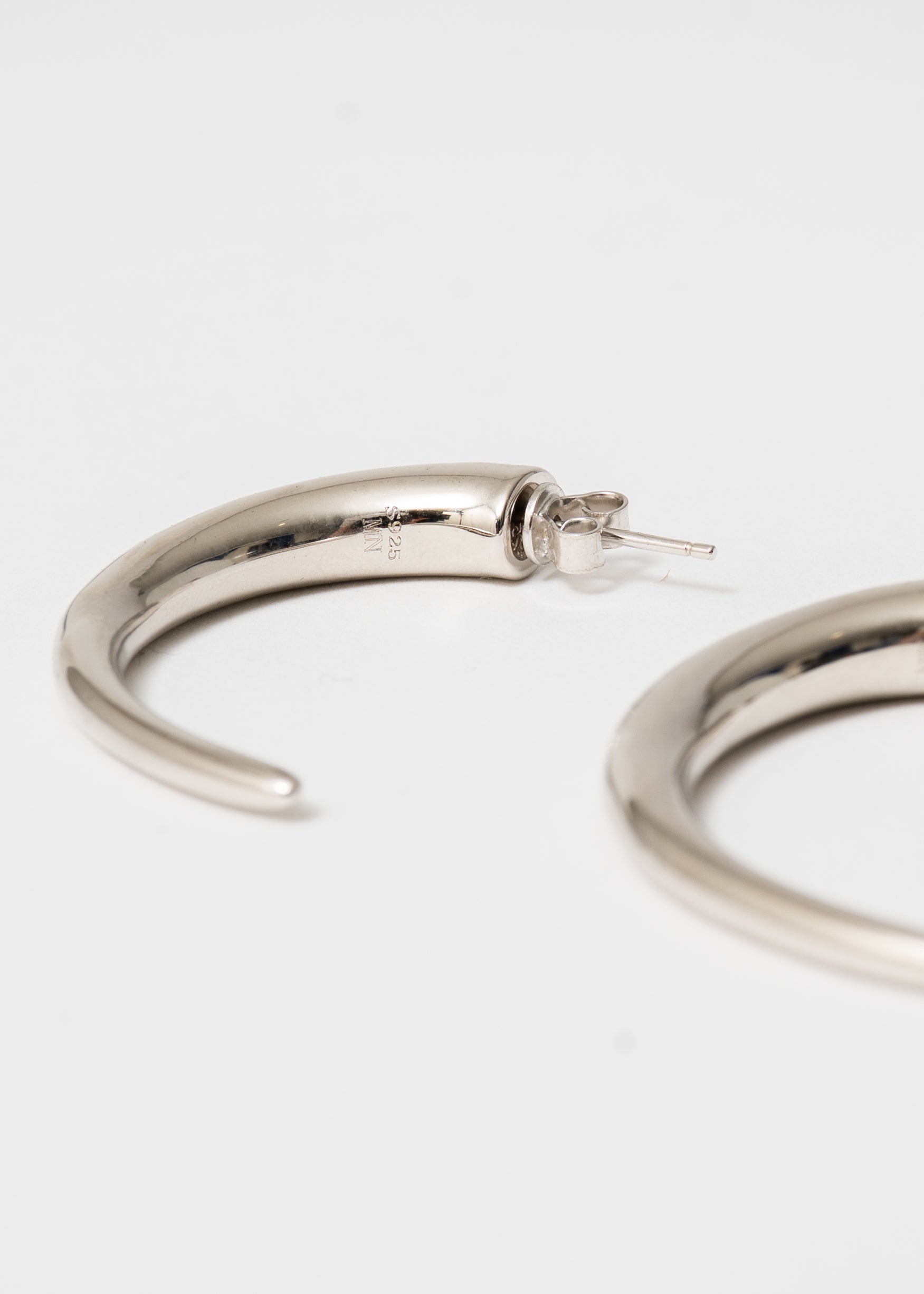 Tapered sterling silver hoop by Maison Nwar — handcrafted texture with sculptural edge