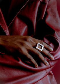 Model wearing Maison Nwar ring, close-up on hands