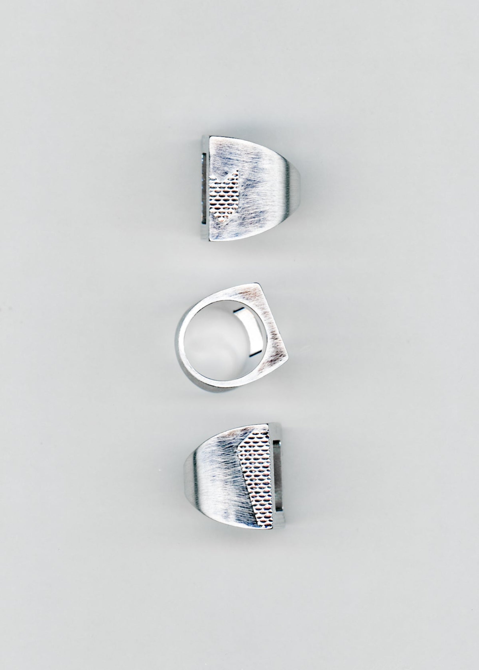 Maison Nwar ring set shown from multiple angles on grey background