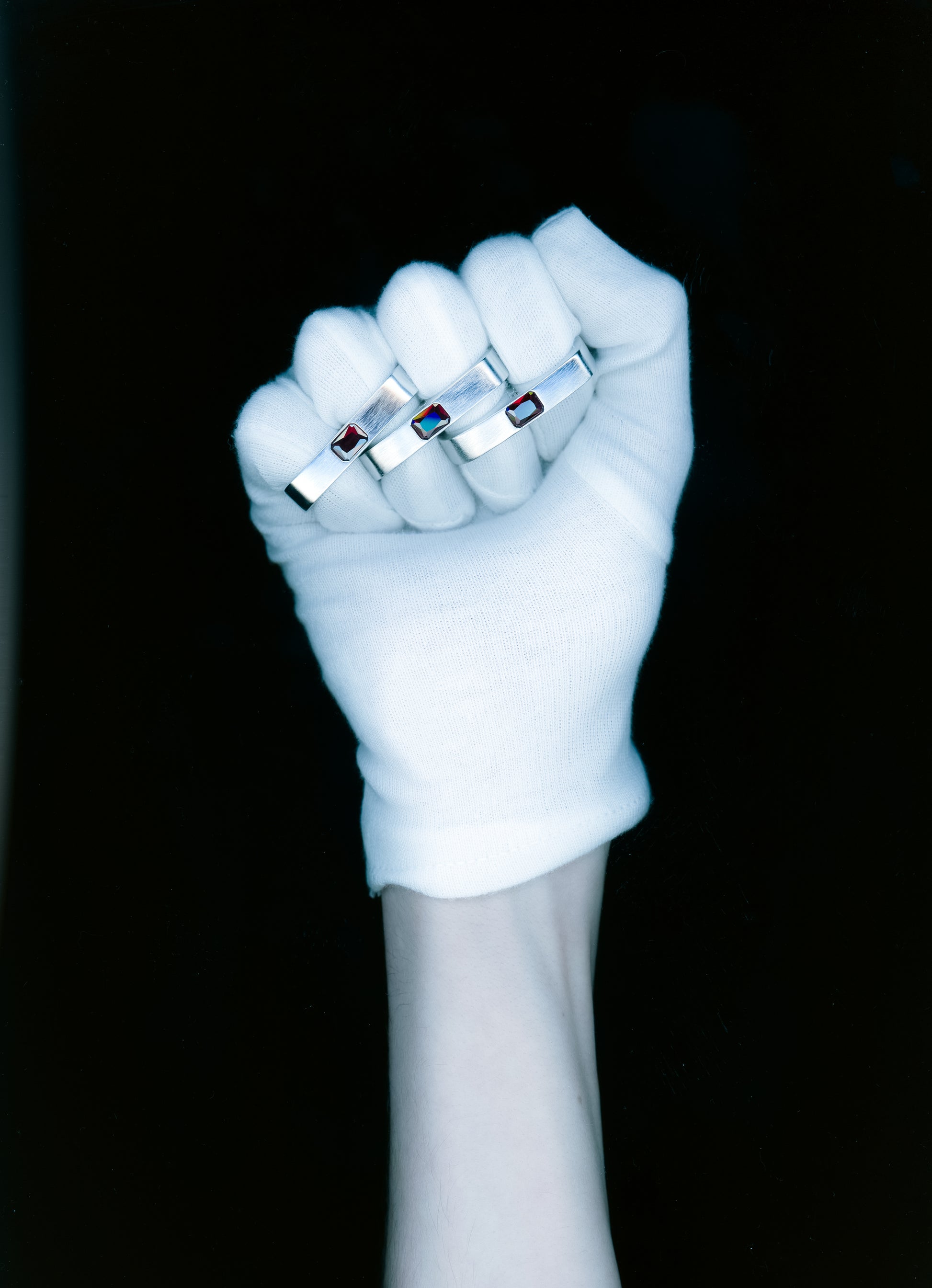 Maison Nwar ring worn on hand, sculptural silver band with red stone