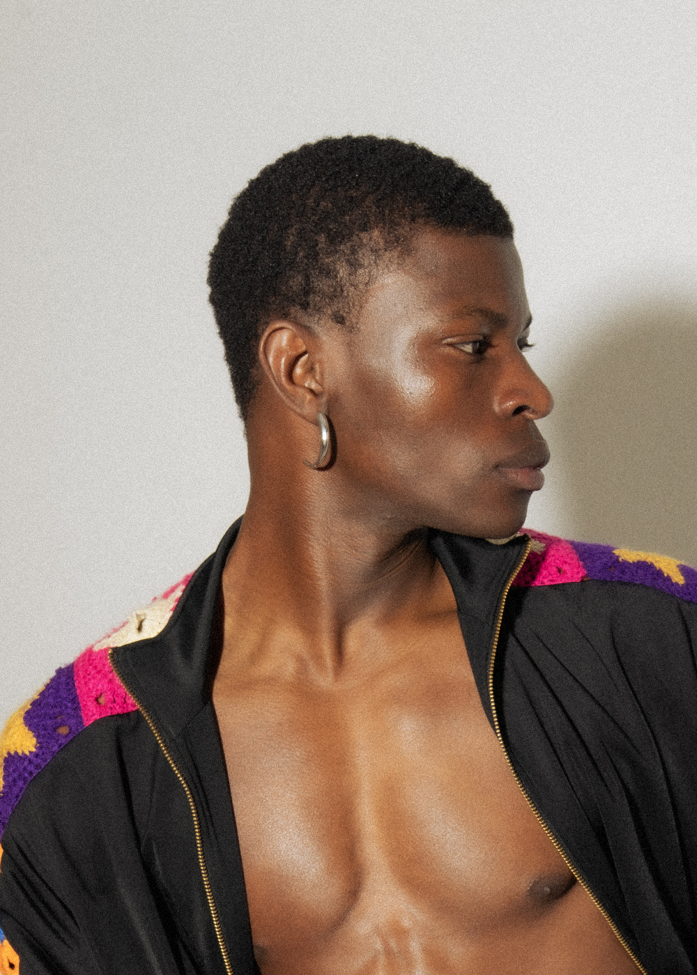 Model wearing Maison Nwar silver hoop earring — minimal, crescent form design